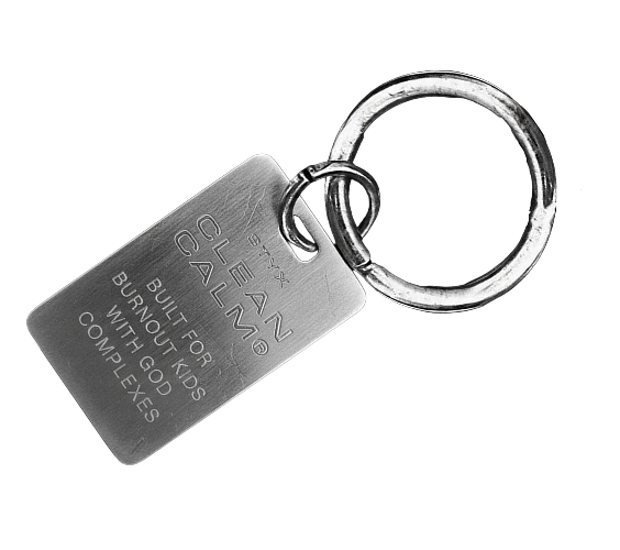 A metal CLEAN CALM keyring engraved 'Built for burnout kids with god complexes'